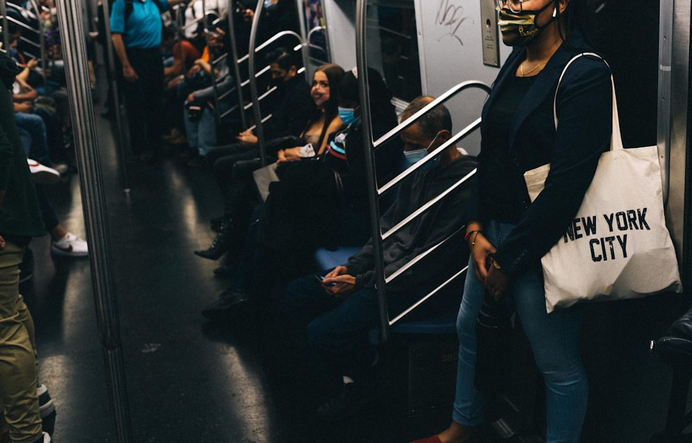 man in black jacket and blue denim jeans standing beside woman in black jacket