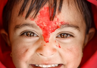 woman in red hijab with white powder on her face