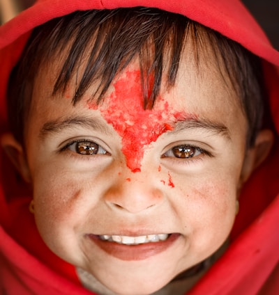 woman in red hijab with white powder on her face