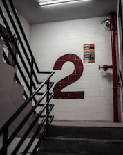 black metal staircase near white wall