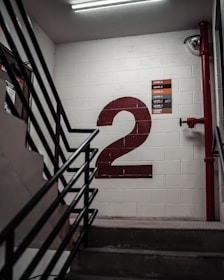 black metal staircase near white wall