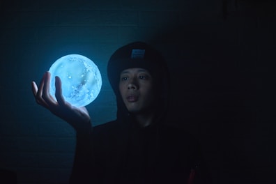 A cozy hoodie featuring a whimsical Elyndra planet graphic glowing under soft light.