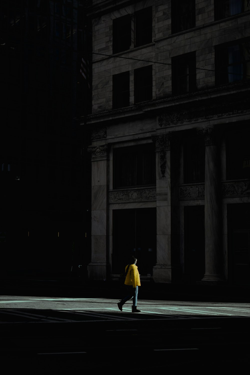 woman in yellow dress walking on street during nighttime