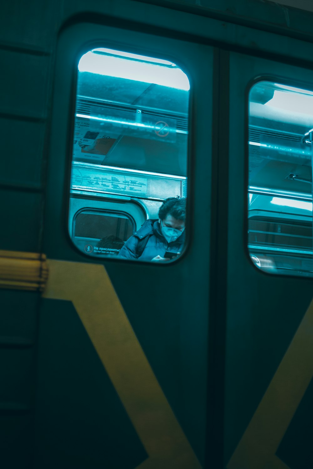 man in black jacket sitting inside train