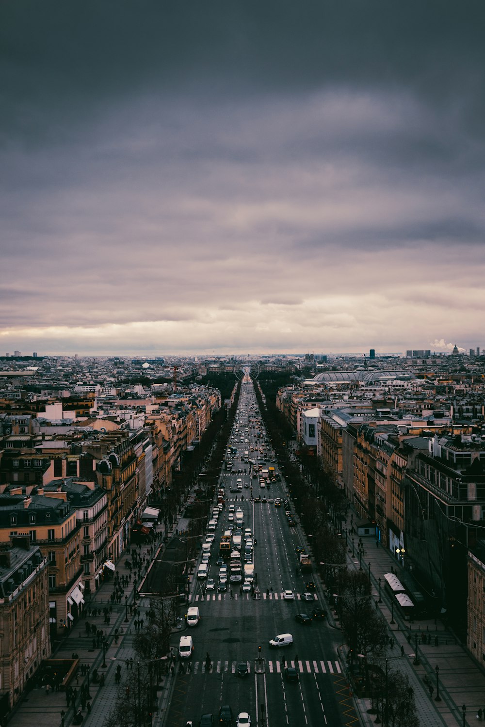 city with high rise buildings under gray sky during daytime