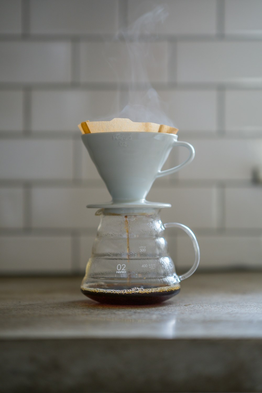 clear glass coffee pot on brown wooden table