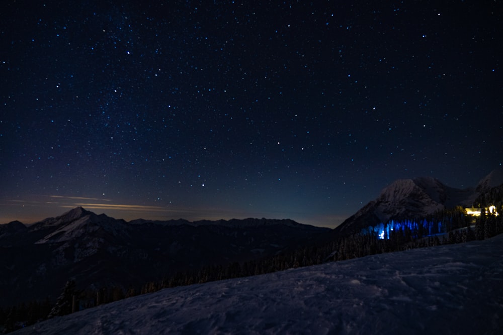 silhouette of mountain under blue sky during night time