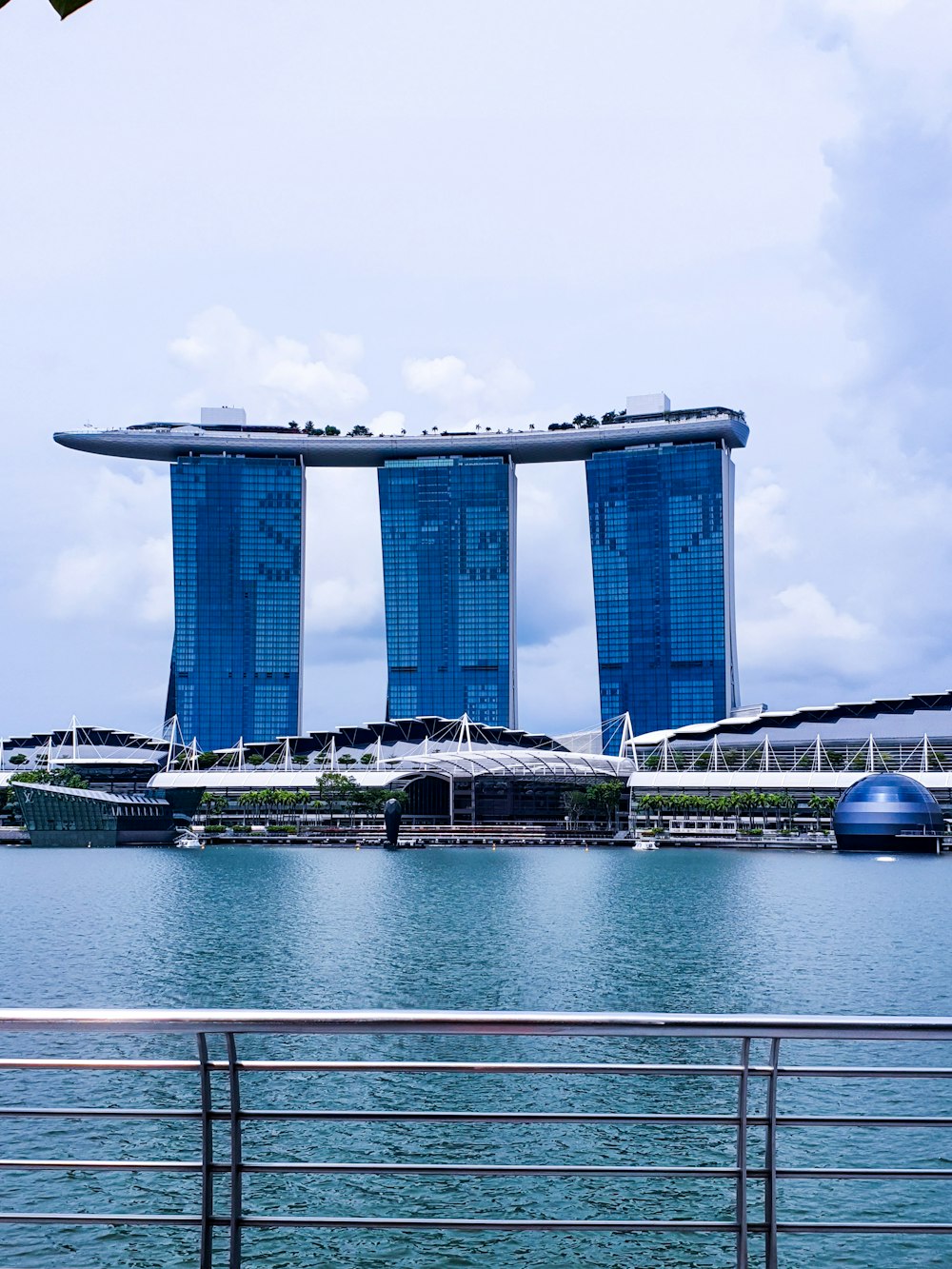 white and blue concrete building near body of water during daytime