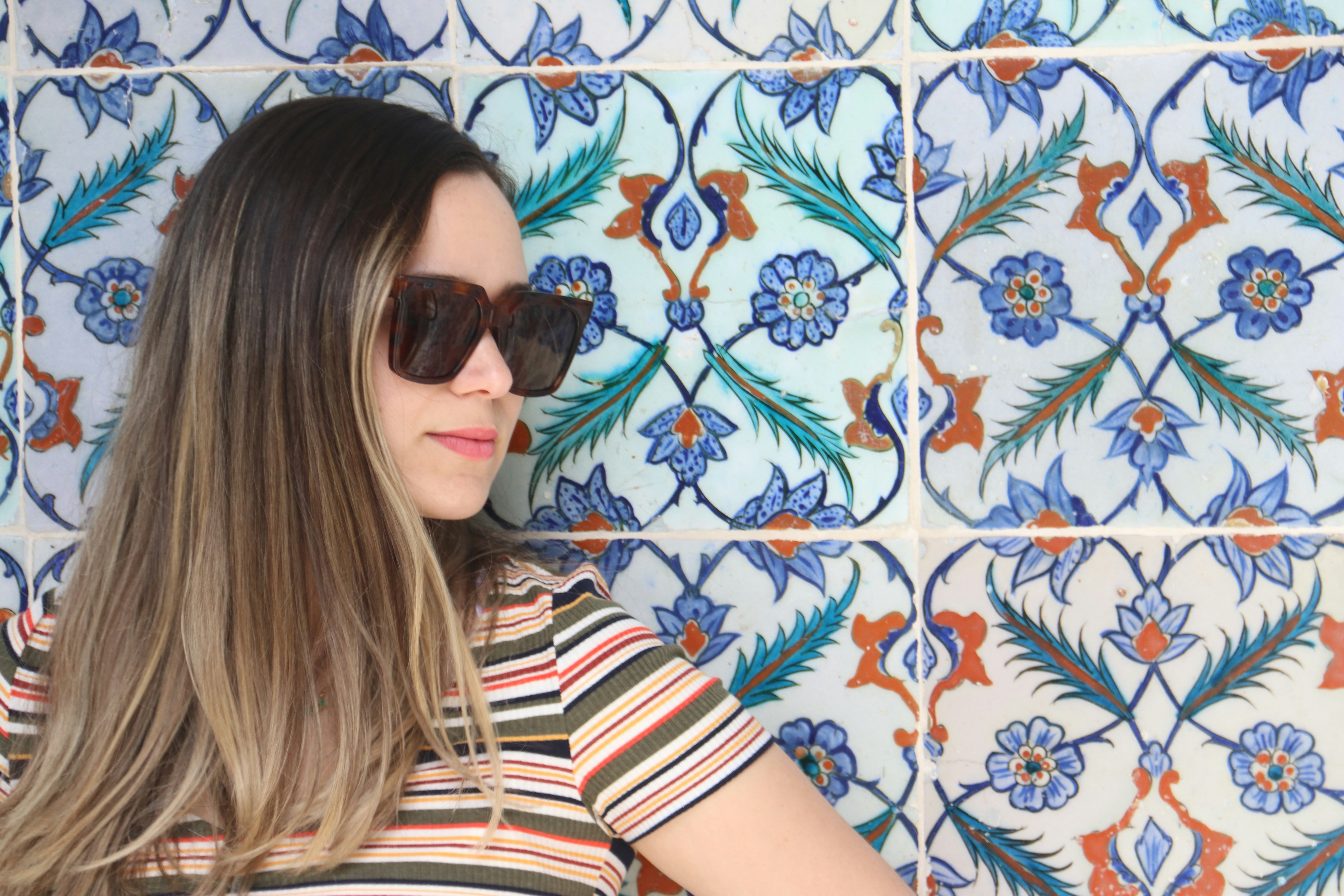 woman in black and white striped shirt wearing black sunglasses