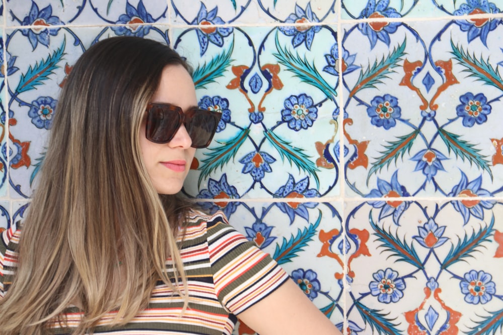 woman in black and white striped shirt wearing black sunglasses