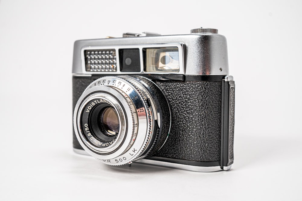 black and silver camera on white surface