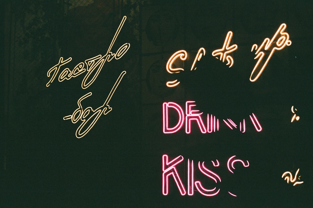 a neon sign that says happy birthday and draw kiss