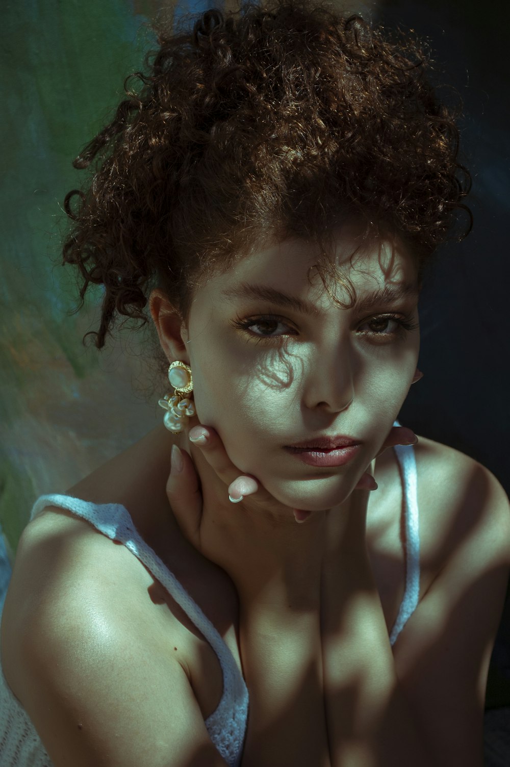 woman in white tank top with white flower on ear