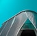 An architectural structure featuring a modern, curved design with a pattern of diagonal lines and large glass elements in the facade against a teal sky.
