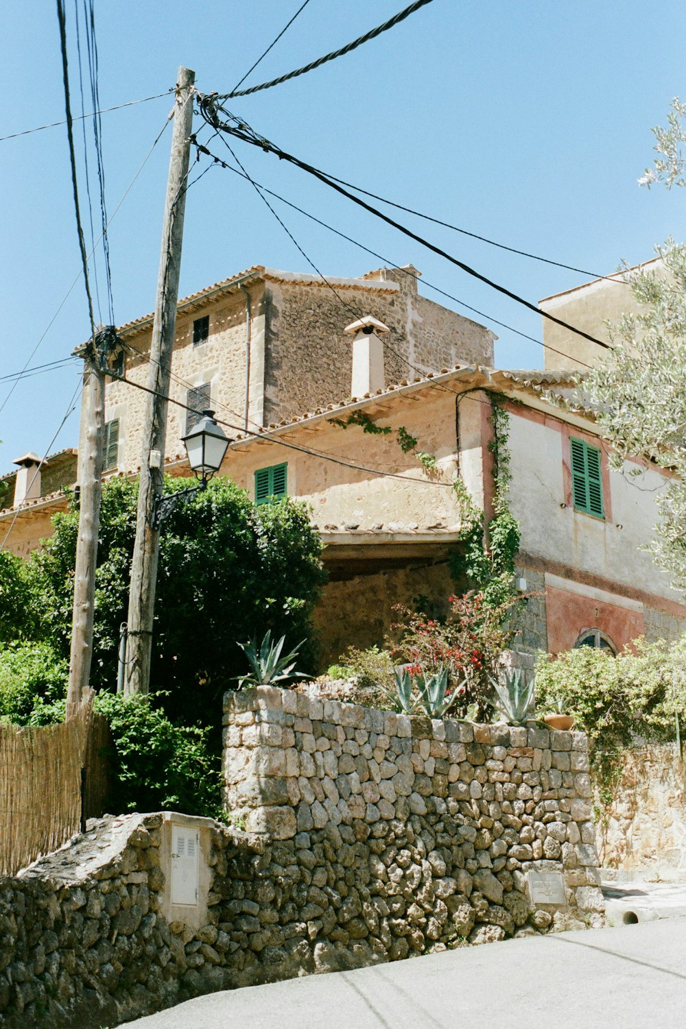 brown brick wall building near green trees during daytime