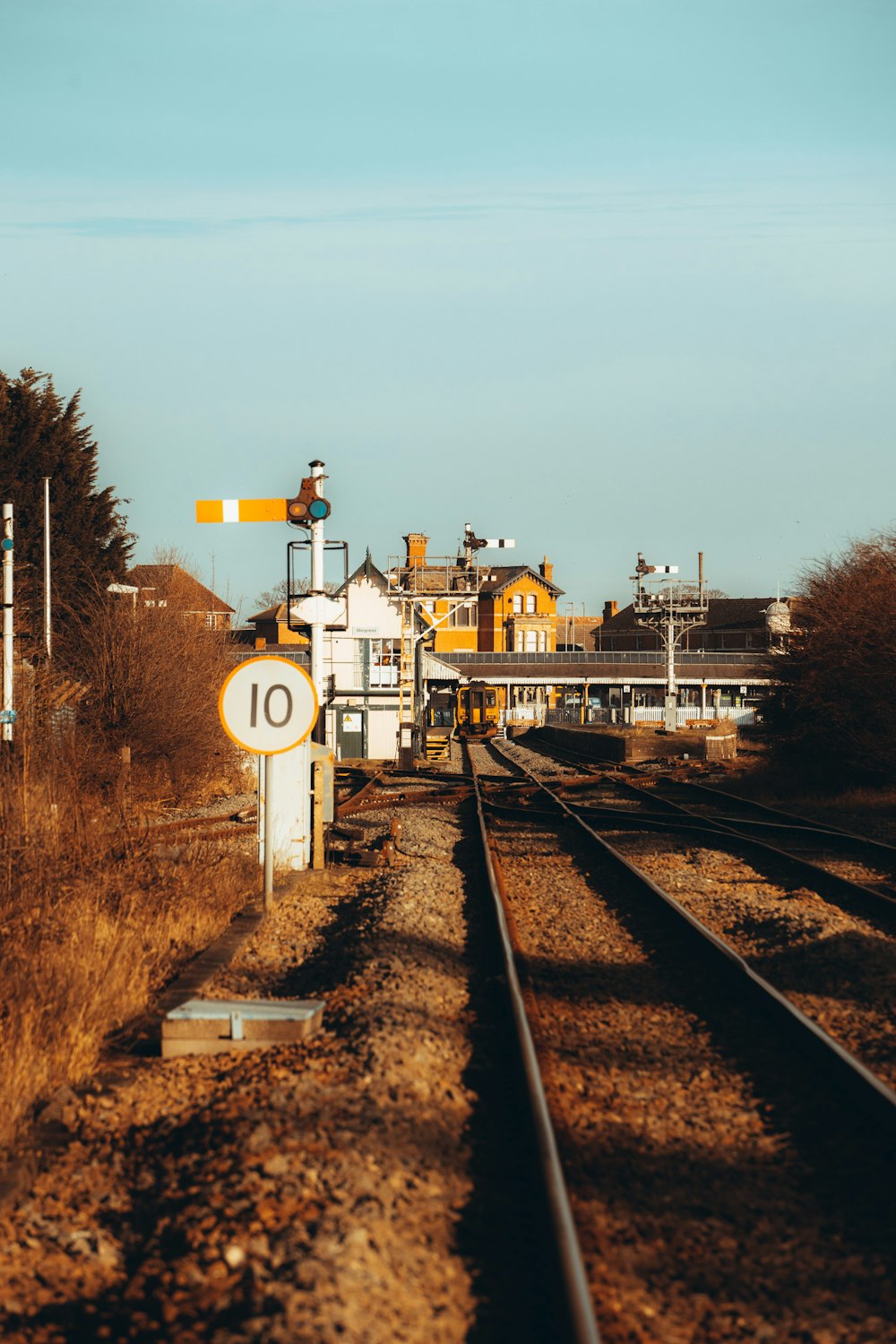 white and brown train on rail tracks during daytime