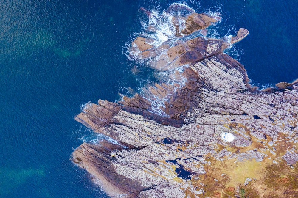 brown rock formation near blue sea during daytime