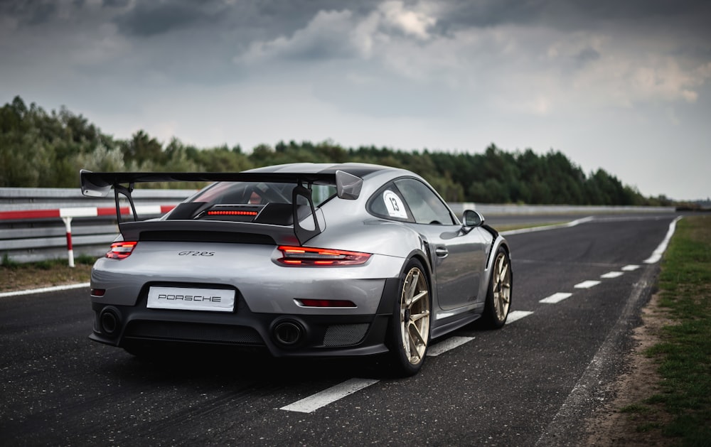 white and red porsche 911 on road during daytime