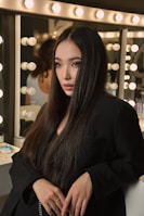 Young woman with long dark hair in a black jacket