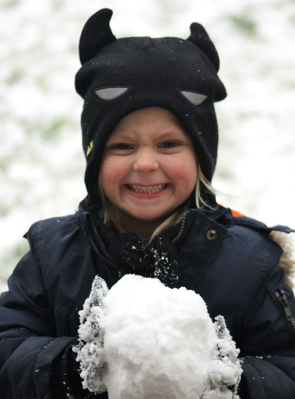 smiling woman in black jacket and black knit cap