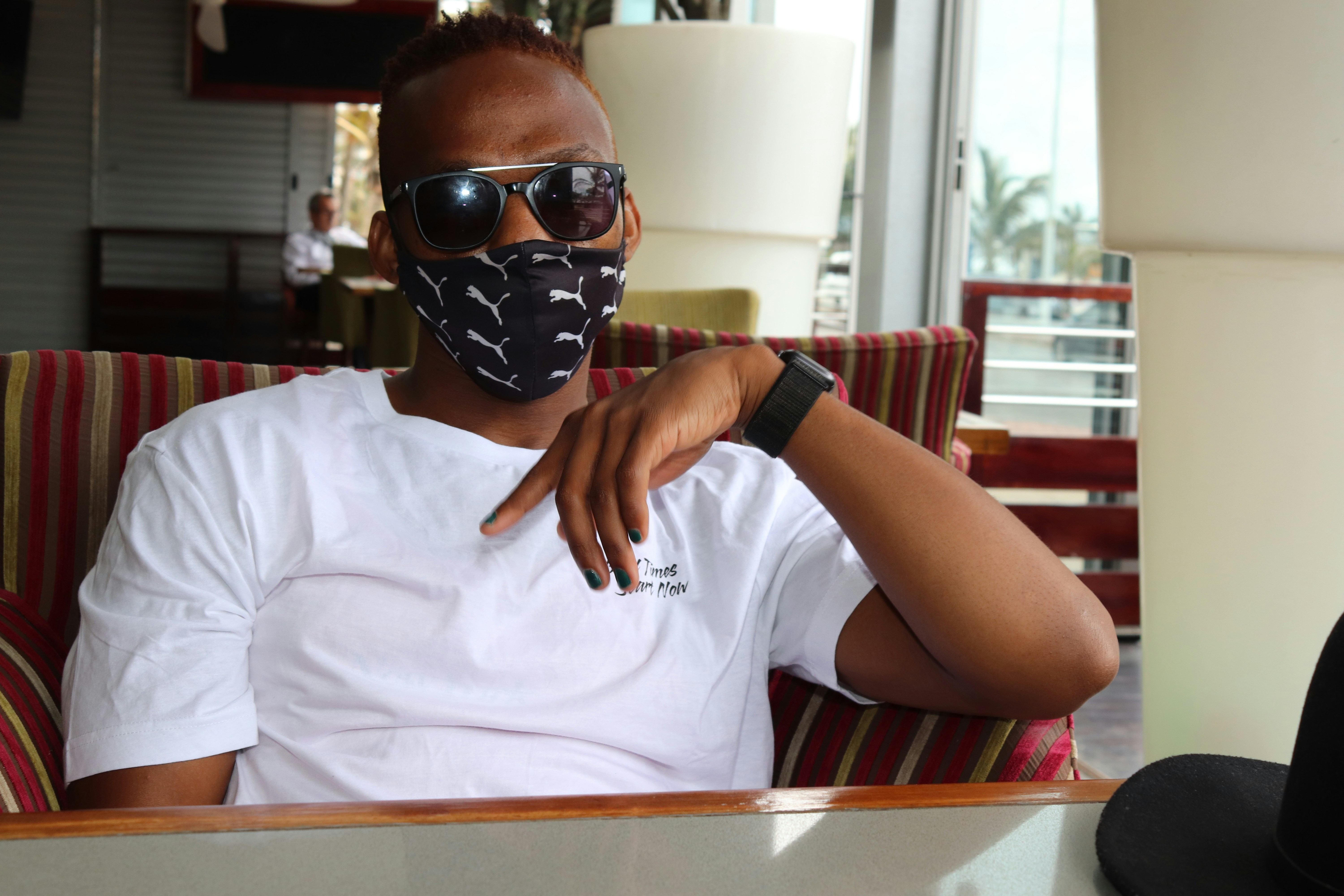 man in white crew neck t-shirt wearing black sunglasses