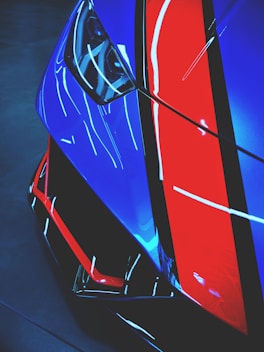 red and blue car in a dark room