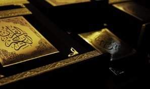 Artistic tasbihs and islamic books arranged aesthetically.