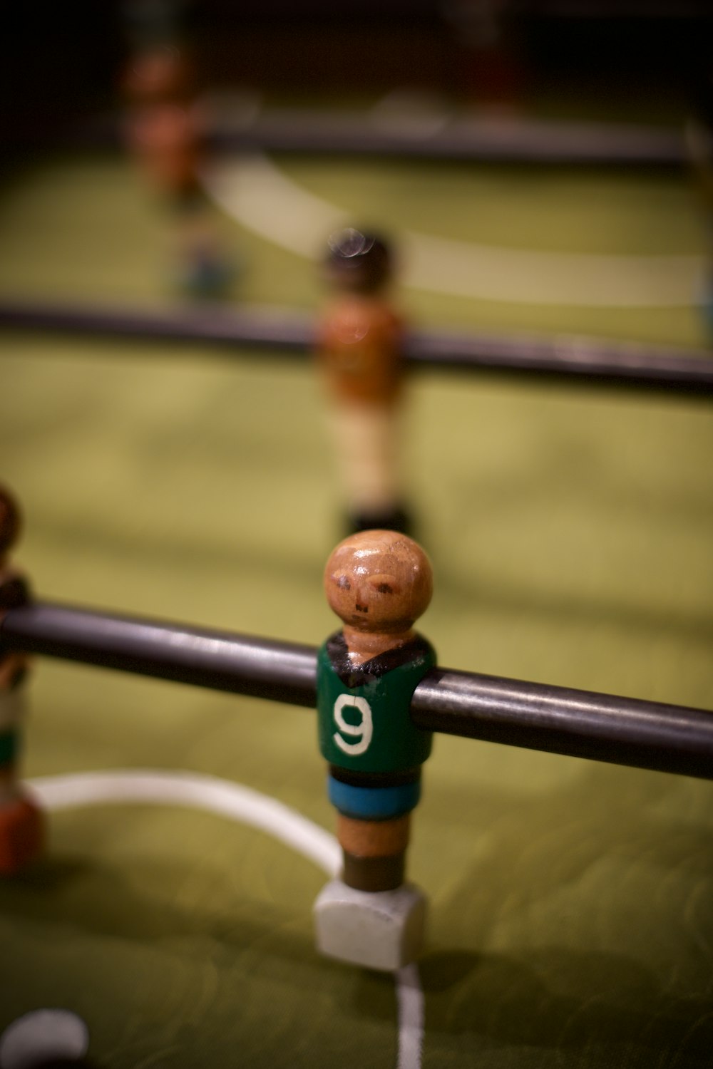 brown wooden chess piece on blue metal fence