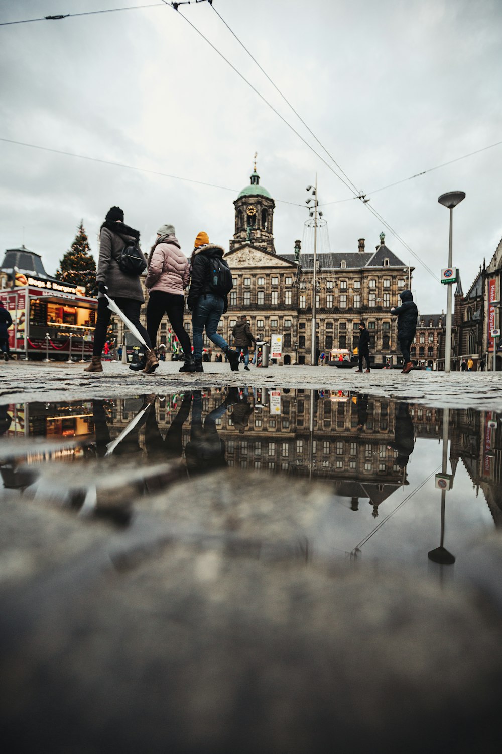 people walking on street near brown and white building during daytime