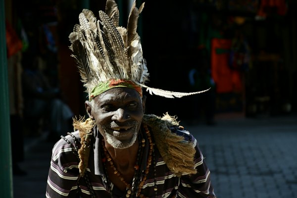 A man in a feathered headdress — Livingstone, Zambia