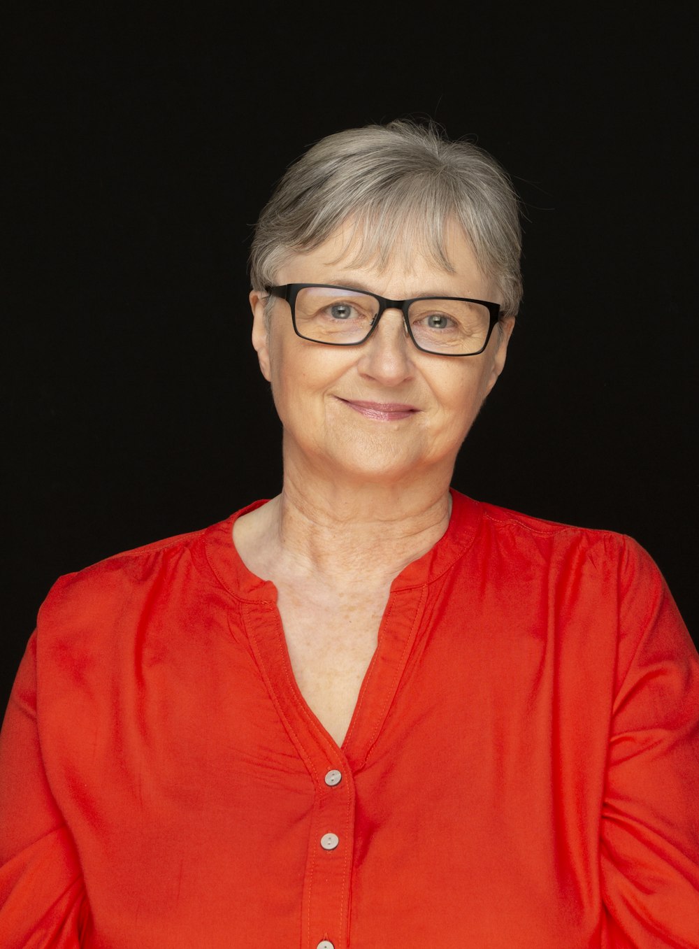 woman in red shirt wearing eyeglasses