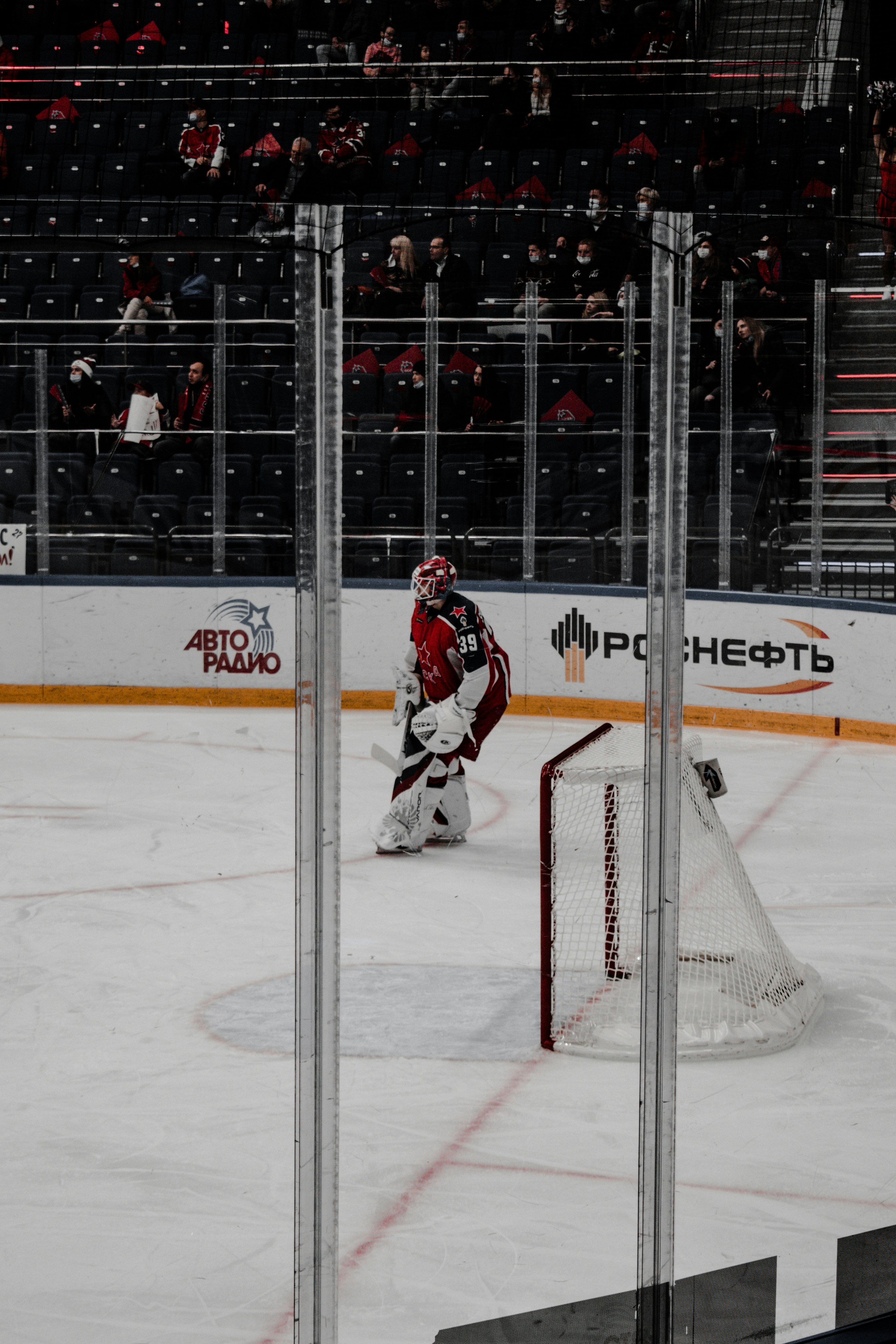 man in white ice hockey jersey playing ice hockey