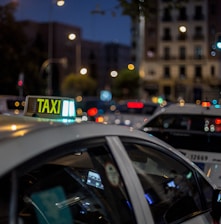 white and black taxi cab on road during night time