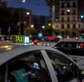 white and black taxi cab on road during night time