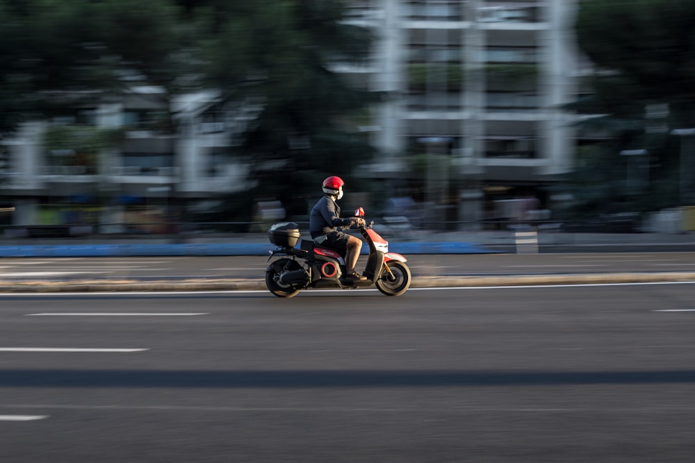 man riding motorcycle on road during daytime