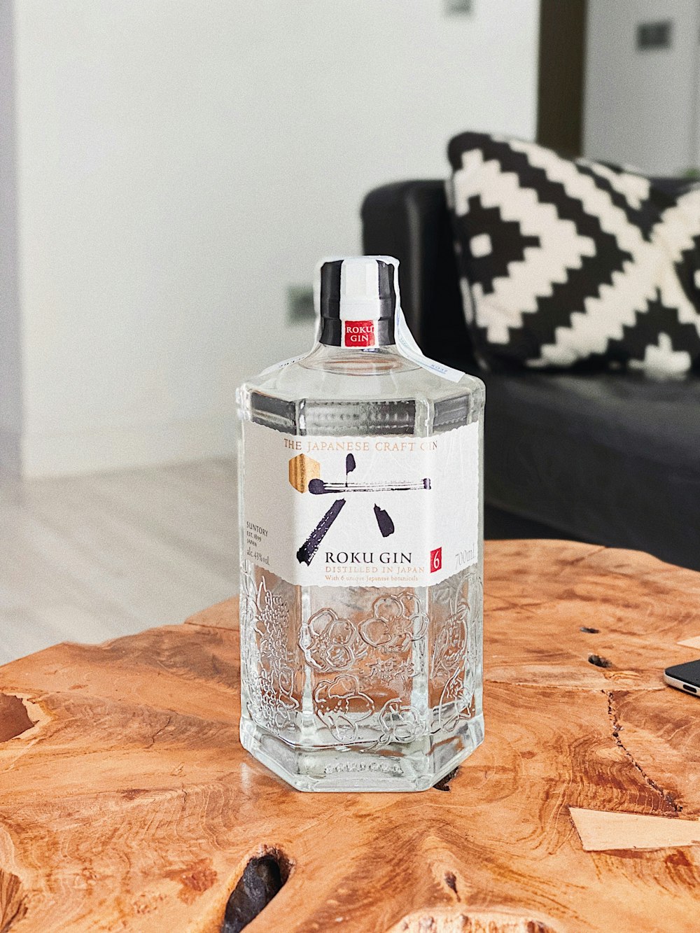 clear glass bottle on brown wooden table