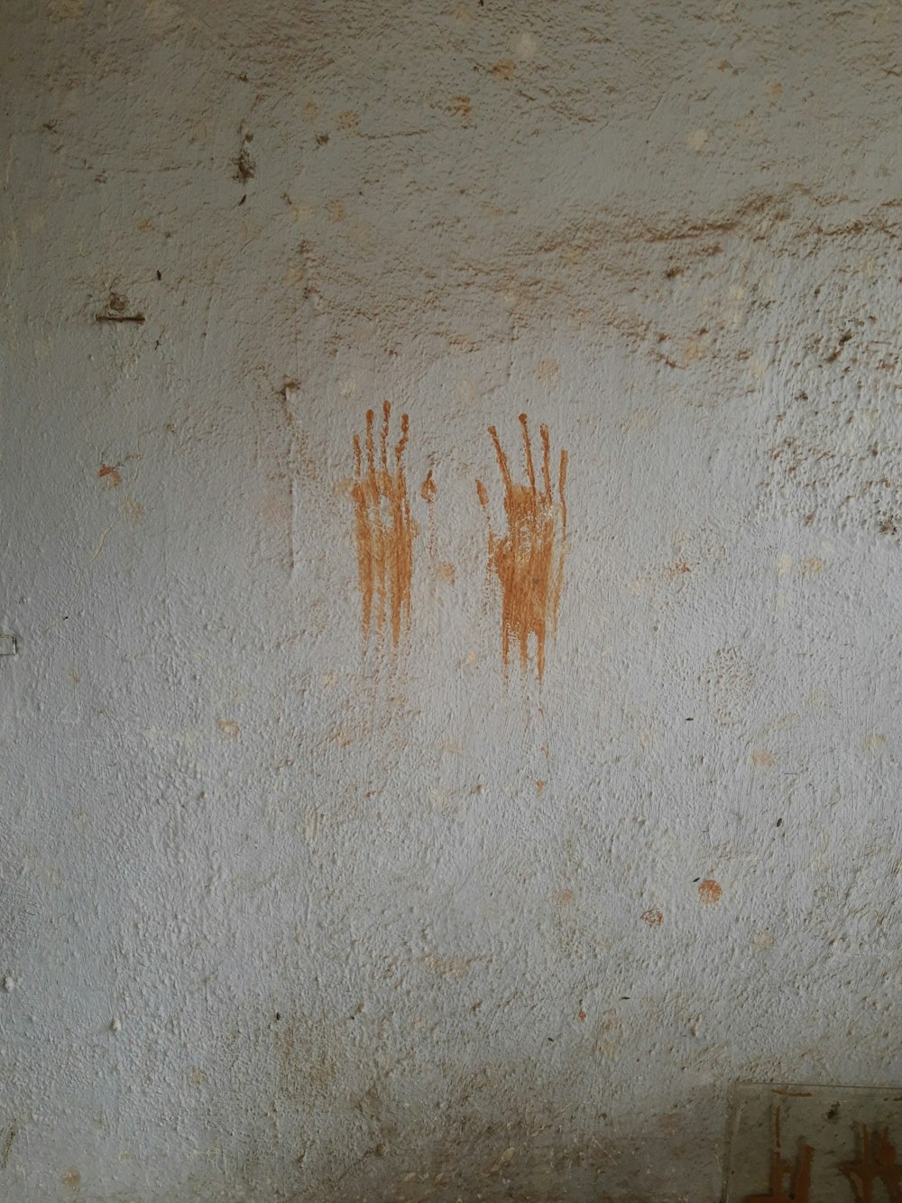 brown powder on white concrete wall