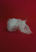 white yarn on red surface