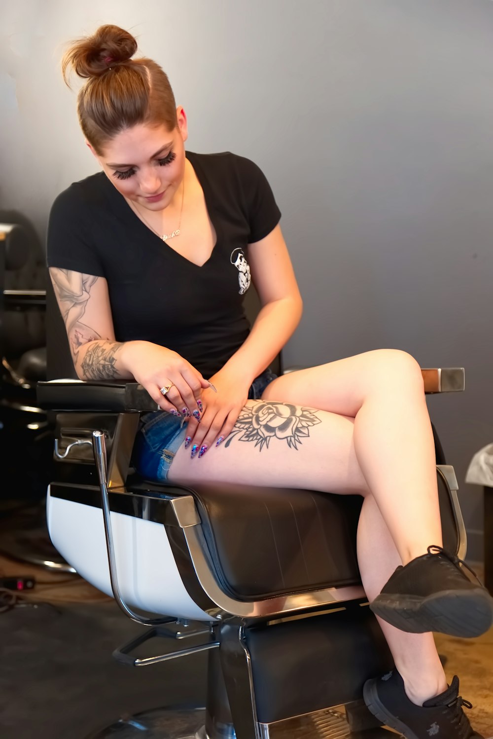 woman in black shirt sitting on chair