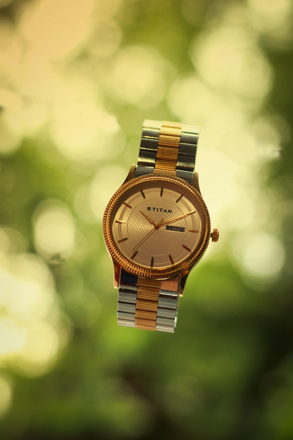 gold and silver round analog watch