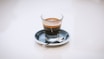 clear glass cup on saucer