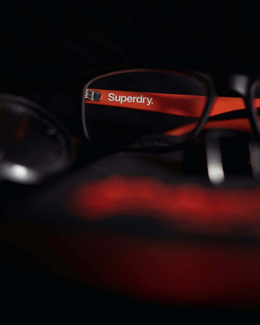 black framed eyeglasses on red textile