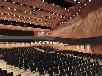 Spacious auditorium with spotless floors and neatly arranged chairs after cleaning