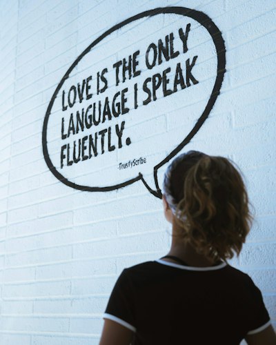 A person sitting alone by a window, looking thoughtful before a difficult conversation