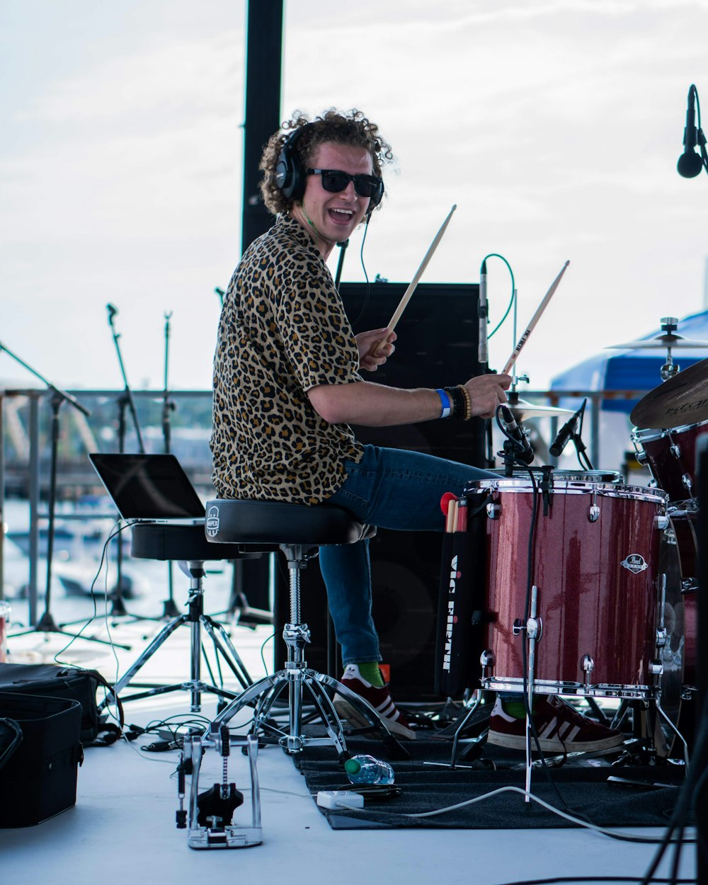 man in brown and black leopard print dress shirt playing drum