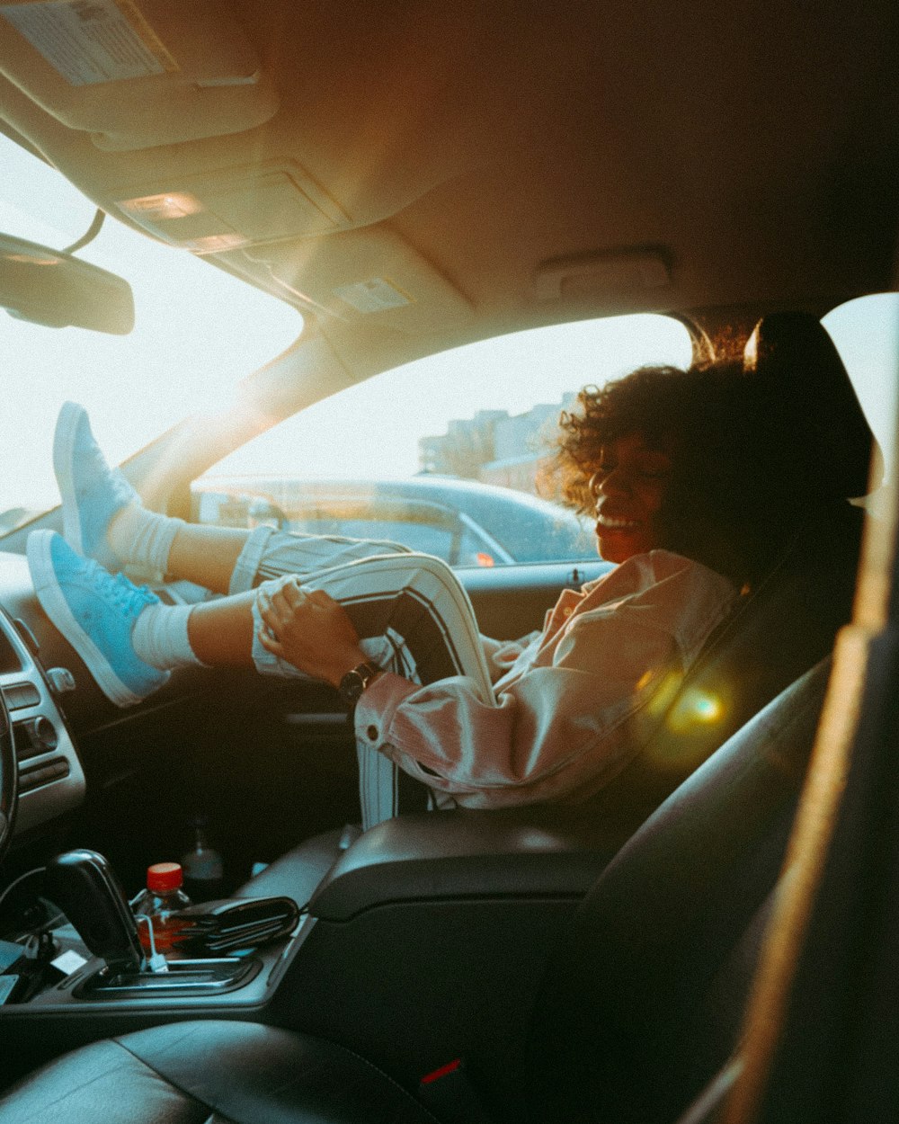 woman in white long sleeve shirt driving car during daytime