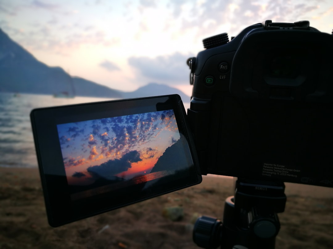black dslr camera taking photo of mountain during daytime