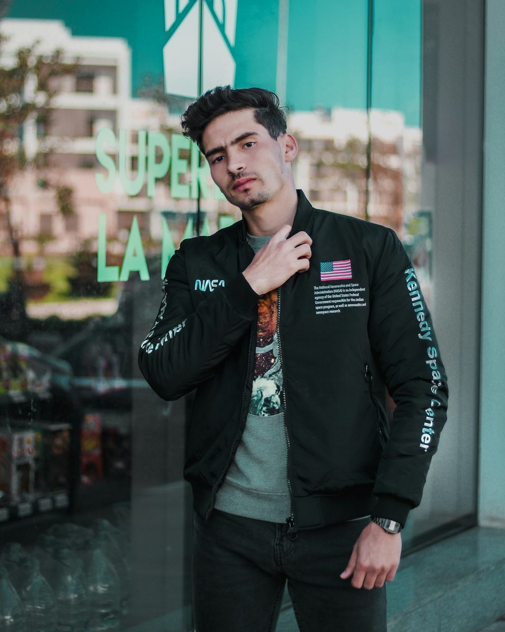 man in black leather jacket standing and smiling