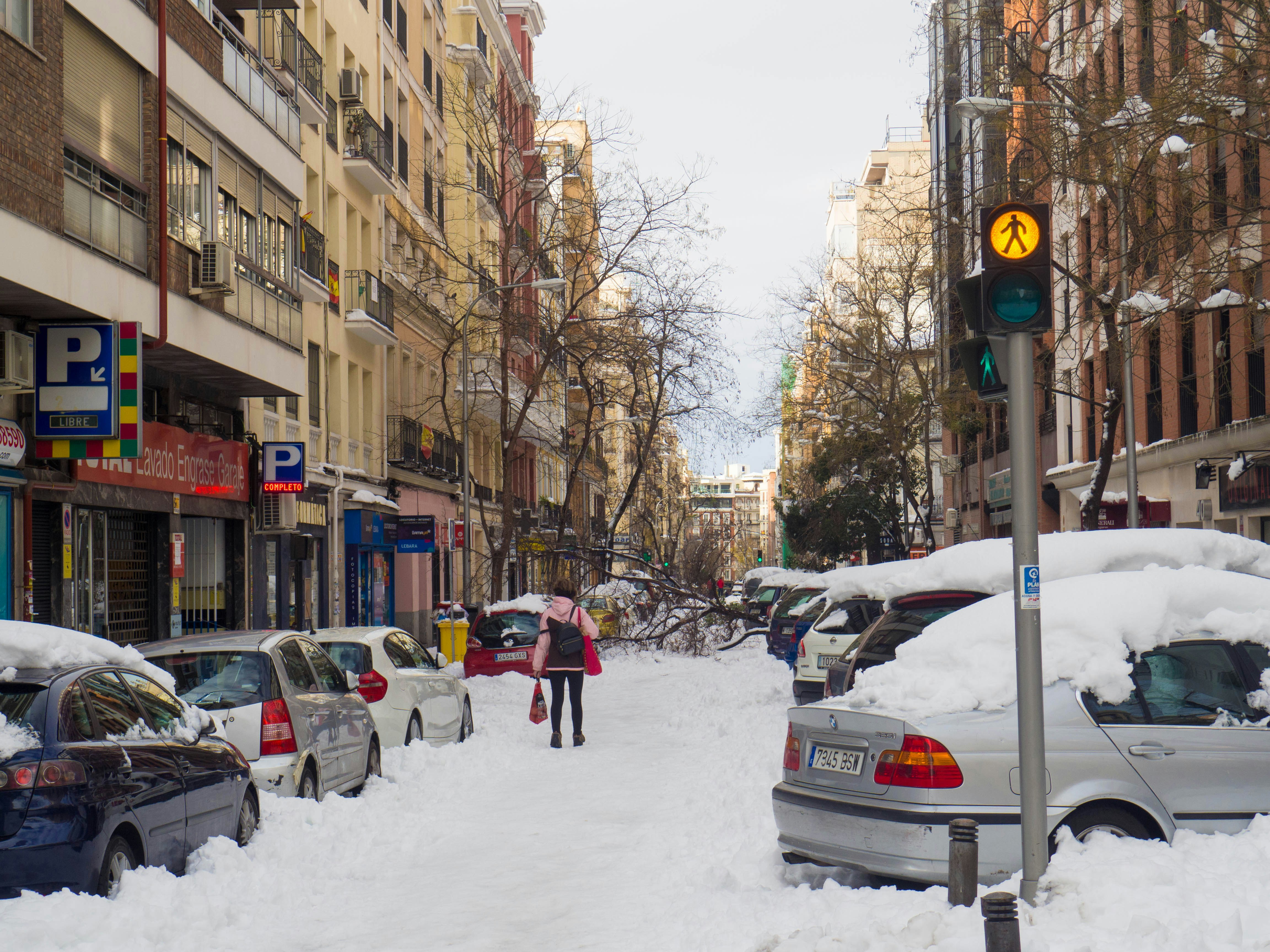 people walking on street covered with snow during daytime