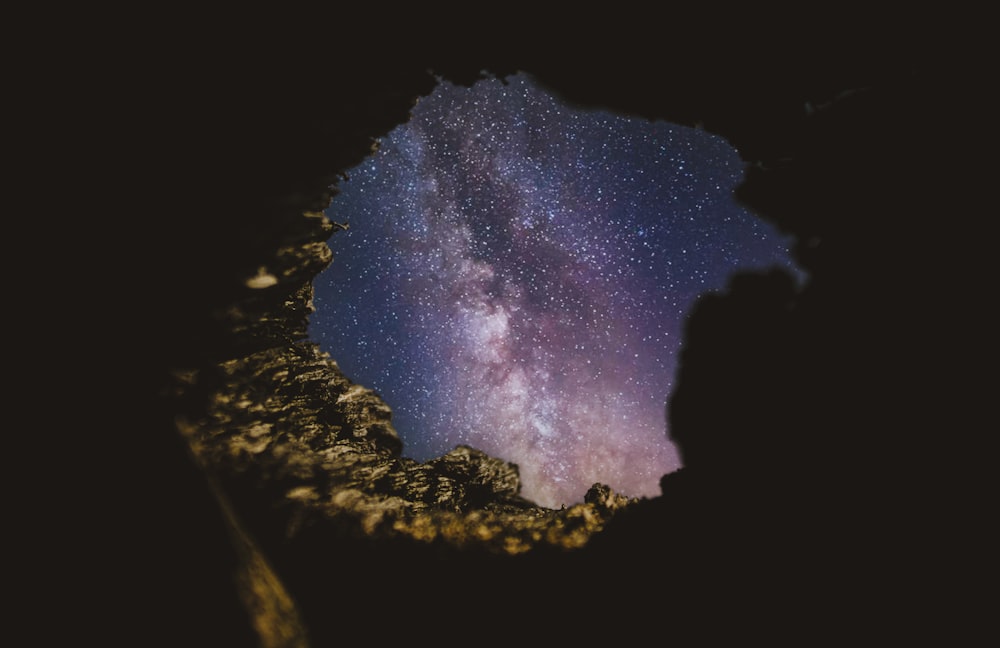 silhouette of mountain under starry night